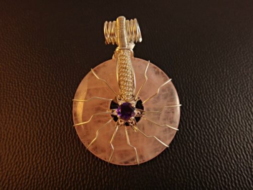 The Flower of Life Rose Quartz design features a faceted Amethyst in the center of the Sun's rays,gives life to a six pointed flower representing mother.