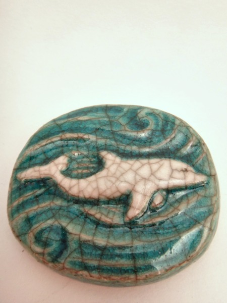 This Raku Medallion Dolphin makes the perfect small and affordable gift for all dolphin lovers!  On the back is inscribed "I am playful."  The dolphin as a spirit animal represents harmony, balance, & play.